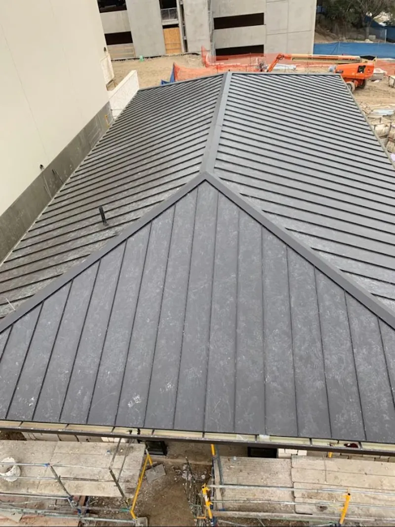 Commercial metal roof construction with crane equipment in Clemson University