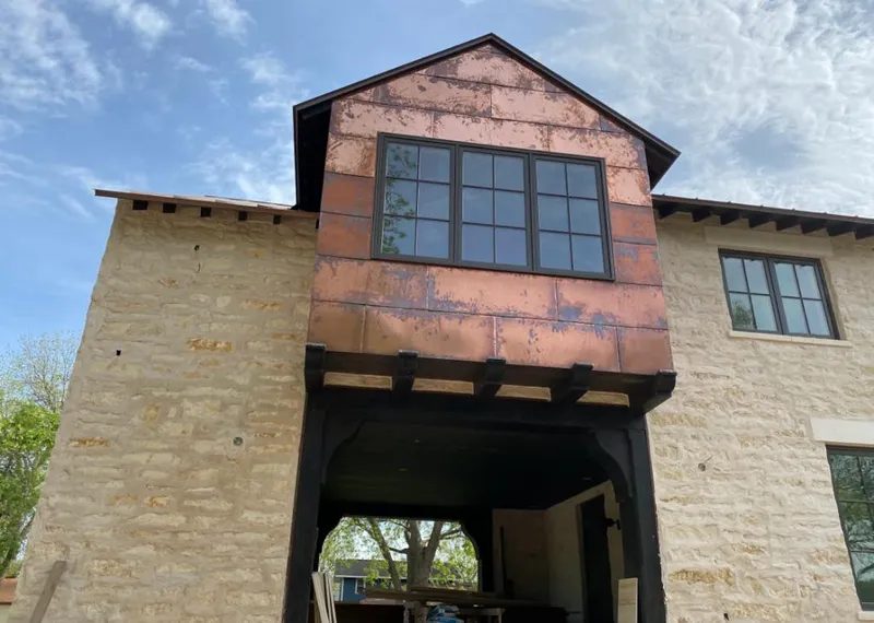 Copper metal panel facade on a stone building for Metal Roof Coating in Clemson University