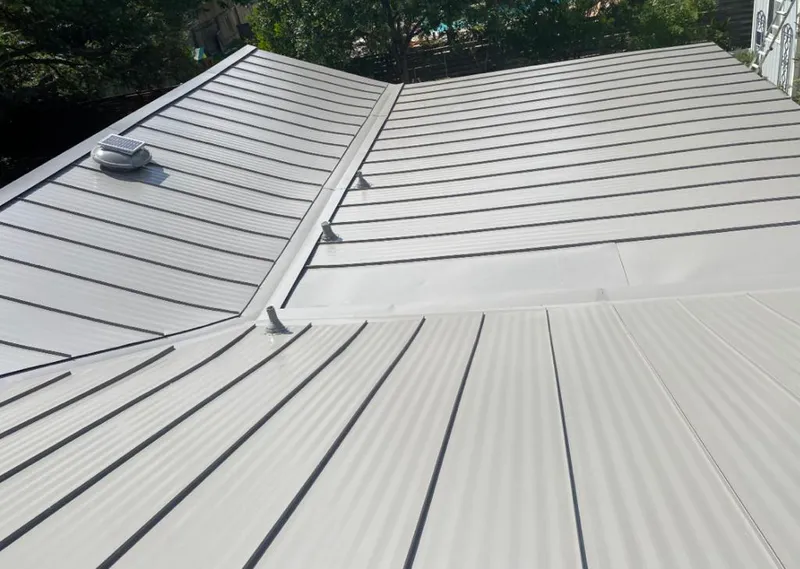 Solar attic fan installed on a metal roof for Roof Ventilation in Clemson University
